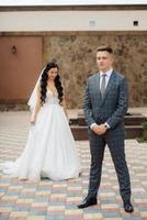the first meeting of the bride and groom in the courtyard of the hotel photo