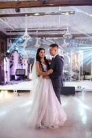 the first dance of the bride and groom inside a restaurant photo