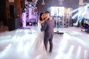 the first dance of the bride and groom inside a restaurant photo