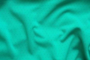 Green sports clothing fabric football shirt jersey texture background photo