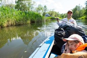 Family kayak trip. Father and daughter rowing boat on the river, a water hike, a summer adventure. Eco-friendly and extreme tourism, active and healthy lifestyle photo