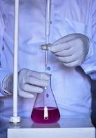 The chemist measures with precision in acid-base titration, adding solutions until neutralization photo