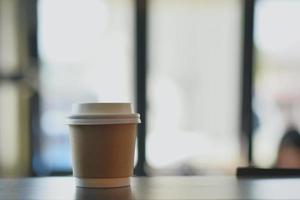 Hot paper cup disposable take away in coffee shop photo