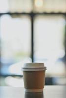 Hot paper cup disposable take away in coffee shop photo