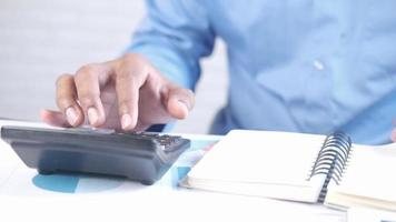 Man hand using calculator and turning pages video
