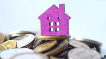 The concept of finance concept with stack of coins and house on table video