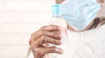 old woman holding hand sanitizer gel video