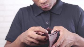 sad man holding empty wallet video