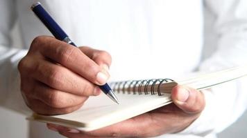 man hand writing to do list on a notebook video