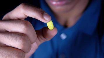 Close up of person hand holding a pill video