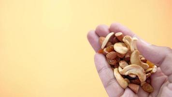 close up of many mixed nuts on hand with copy space video