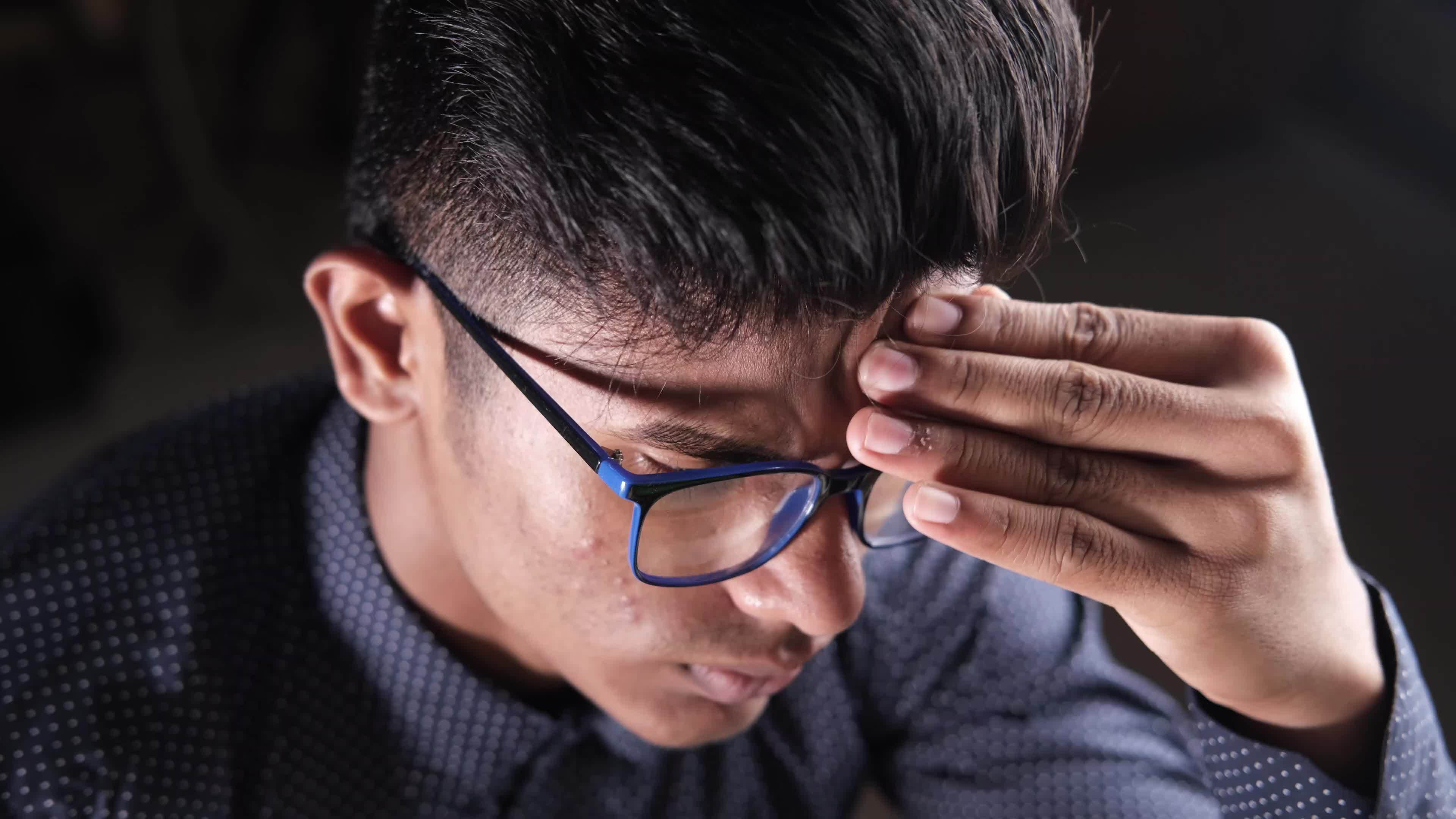 Young man cover his face with hand suffering headache 22649185 Stock