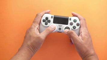 Close up of person hand using game controller and playing galmes video