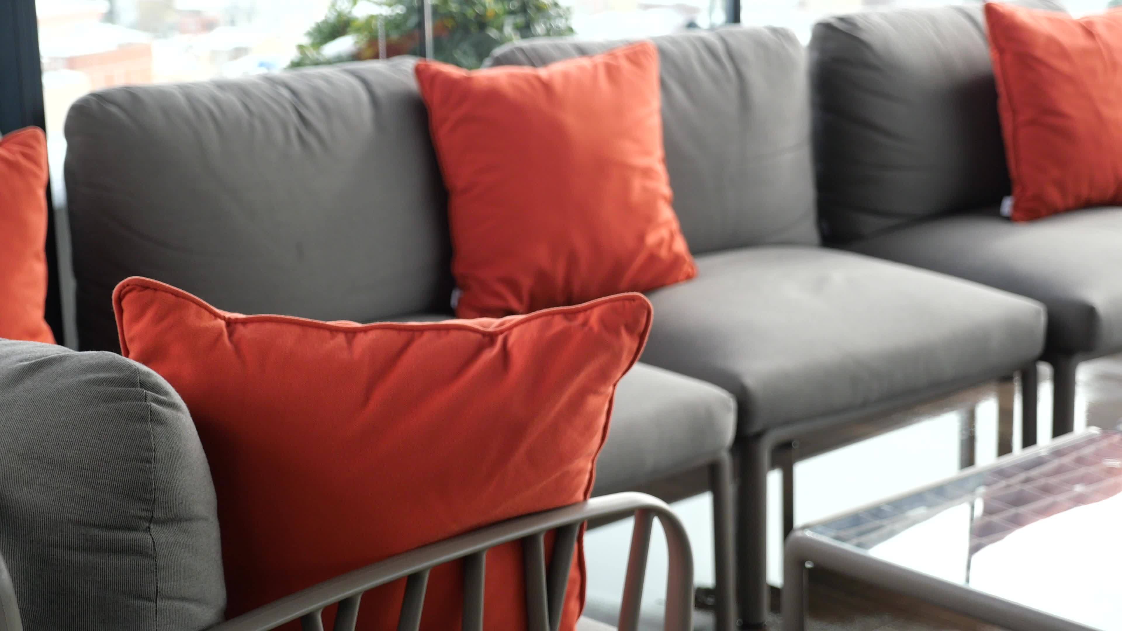 modern grey sofa with pillows in living room at home. High quality