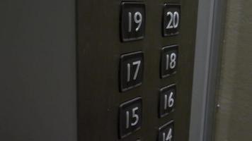 Hand pressing lift button up to high floor of office building or hotel condominium. video