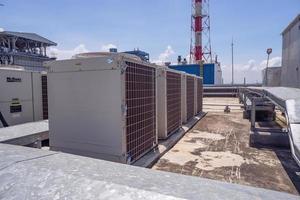 Array of outdoor fan air conditioner on the roof top building. The photo is suitable to use for construction and maintenance of air conditioner.