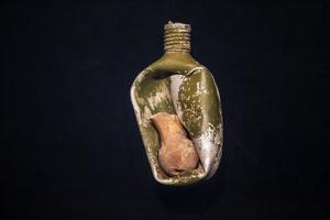 Military flask of the Second World War with the bone of a dead person during the explosion. photo