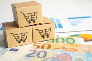 Shopping cart box on graph background with Euro banknotes money. Banking Investment Business import export online concept. photo