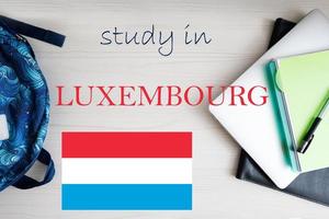 Study in Luxembourg. Background with notepad, laptop and backpack. Education concept. photo