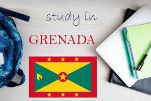 Study in Grenada. Background with notepad, laptop and backpack. Education concept. photo