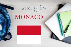 Study in Monaco. Background with notepad, laptop and backpack. Education concept. photo