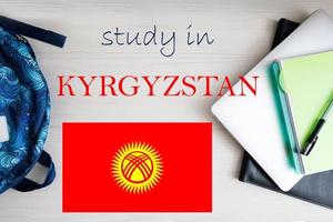 Study in Kyrgyzstan. Background with notepad, laptop and backpack. Education concept. photo