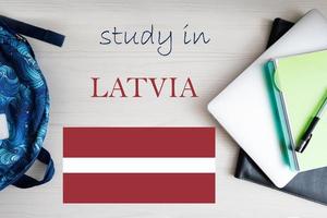 Study in Latvia. Background with notepad, laptop and backpack. Education concept. photo