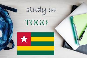 Study in Togo. Background with notepad, laptop and backpack. Education concept. photo