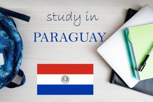 Study in Paraguay. Background with notepad, laptop and backpack. Education concept. photo