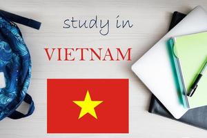 Study in Vietnam. Background with notepad, laptop and backpack. Education concept. photo