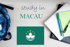 Study in Macau. Background with notepad, laptop and backpack. Education concept. photo