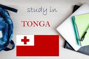 Study in Tonga. Background with notepad, laptop and backpack. Education concept. photo