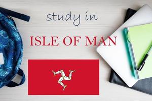 Study in Isle of Man. Background with notepad, laptop and backpack. Education concept. photo