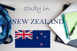 Study in New Zealand. Background with notepad, laptop and backpack. Education concept. photo