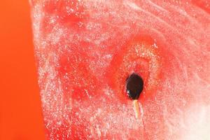 slice of watermelon on orange background close-up. watermelon seed macro photo