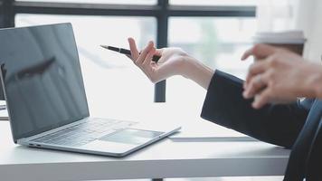 Financial analysts analyze business financial reports on a digital tablet planning investment project during a discussion at a meeting of corporate showing the results of their successful teamwork. video