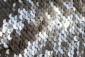 background of silver sequins. shiny sparkling background photo