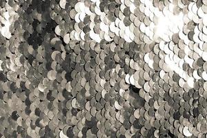 background of silver sequins. shiny sparkling background photo