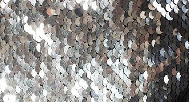 background of silver sequins. shiny sparkling background photo