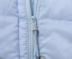 Fragment of a blue jacket with a zipper photo