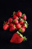 Strawberries on black background photo