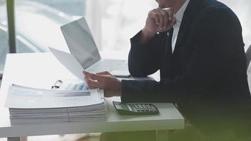 Financial analysts analyze business financial reports on a digital tablet planning investment project during a discussion at a meeting of corporate showing the results of their successful teamwork. video