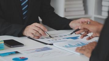 Financial analysts analyze business financial reports on a digital tablet planning investment project during a discussion at a meeting of corporate showing the results of their successful teamwork. video