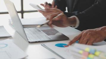 Financial analysts analyze business financial reports on a digital tablet planning investment project during a discussion at a meeting of corporate showing the results of their successful teamwork. video