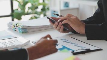 Financial analysts analyze business financial reports on a digital tablet planning investment project during a discussion at a meeting of corporate showing the results of their successful teamwork. video