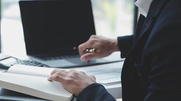 Financial analysts analyze business financial reports on a digital tablet planning investment project during a discussion at a meeting of corporate showing the results of their successful teamwork. video