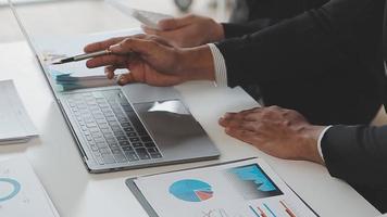 Financial analysts analyze business financial reports on a digital tablet planning investment project during a discussion at a meeting of corporate showing the results of their successful teamwork. video