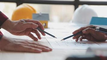 Construction and structure concept of Engineer or architect meeting for project working with partner and engineering tools on model building and blueprint in working site, contract for both companies. video