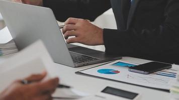 Financial analysts analyze business financial reports on a digital tablet planning investment project during a discussion at a meeting of corporate showing the results of their successful teamwork. video