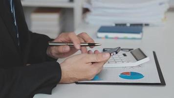 Financial analysts analyze business financial reports on a digital tablet planning investment project during a discussion at a meeting of corporate showing the results of their successful teamwork. video
